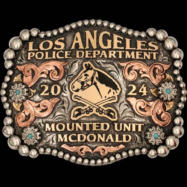"Our Culver City Belt Buckle is the perfect accessory to represent you. Crafted on a German Silver base featuring a three-tone metal design, it showcases hand-engraved Copper western scrolls that highlight the German Silver flowers, complemented by J